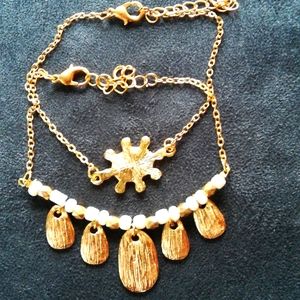 Set (2) gold and white bracelets
